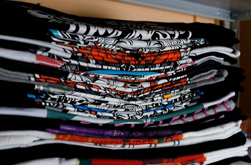 a stack of graphic t-shirts