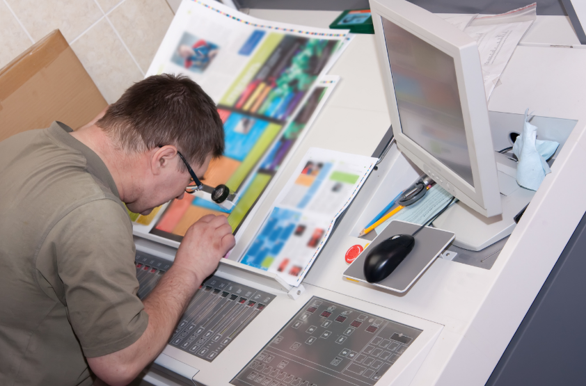man reviewing a print's fine details 
