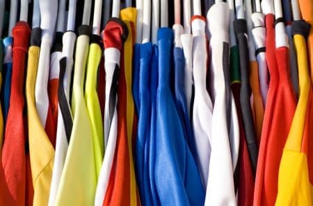 rack of polyester t-shirts on hangers 