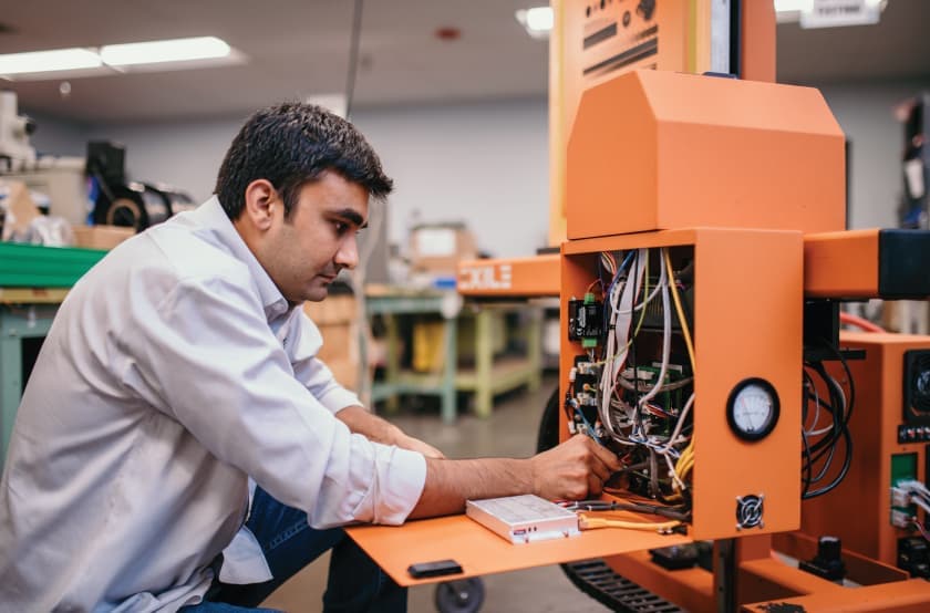 EXILE technician working on  SPYDER system 